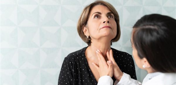 woman getting thyroid checked