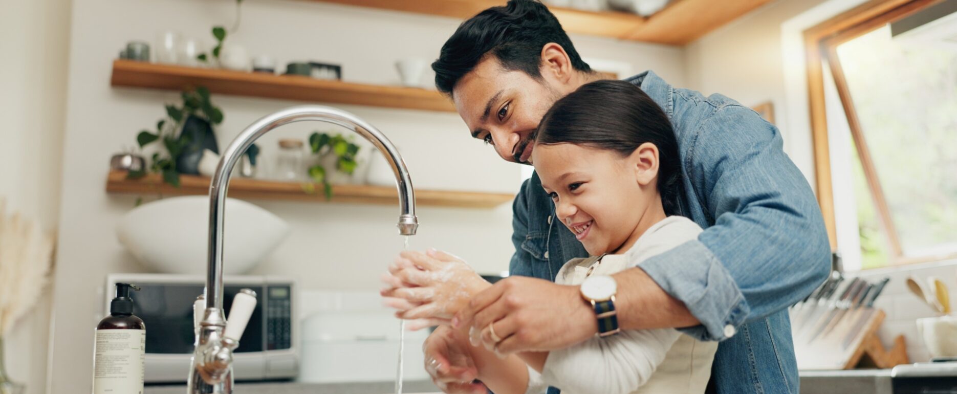Father and child washing hands