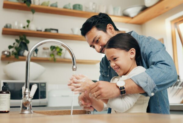 Father and child washing hands