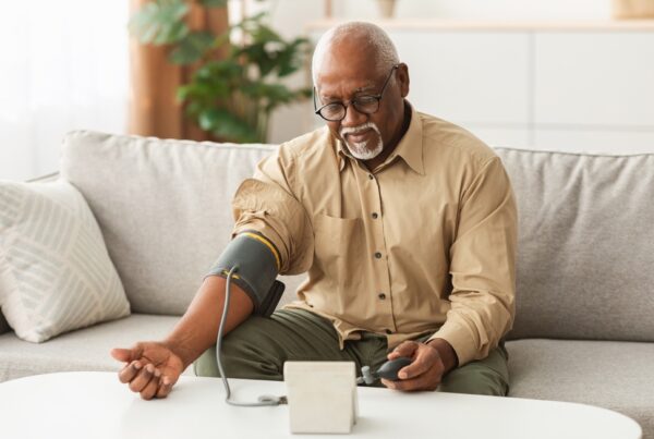older man taking blood pressure