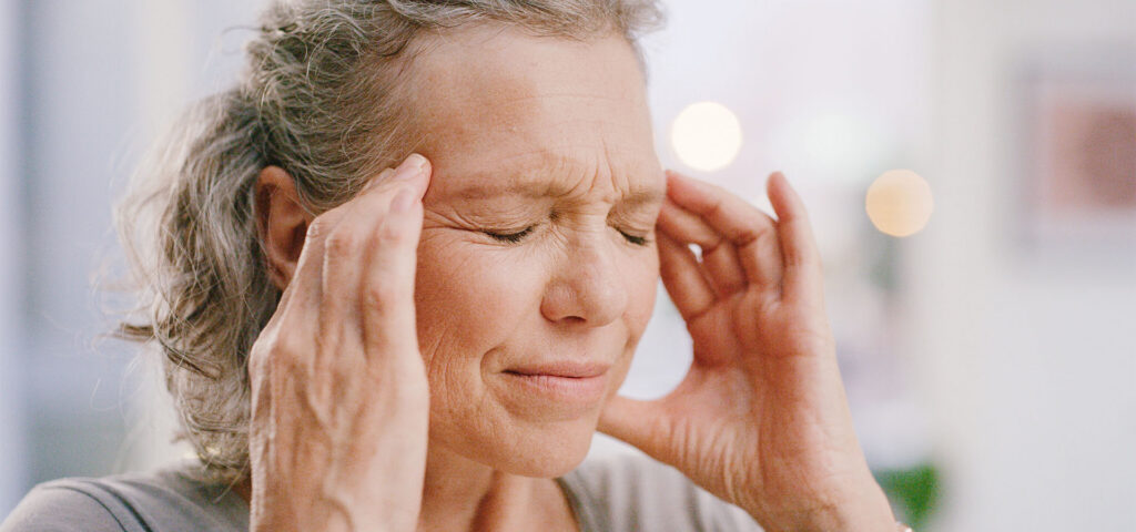 stroke signs - woman with headache